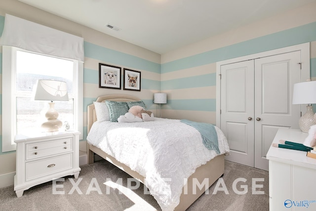 carpeted bedroom with a closet