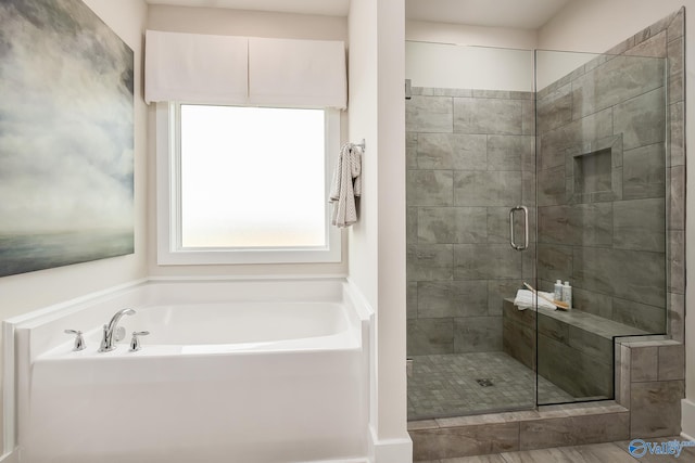 bathroom with separate shower and tub