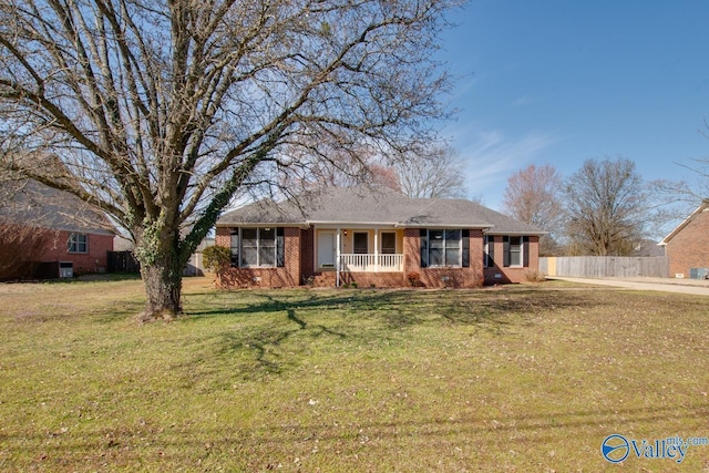 single story home with brick siding, a front yard, and fence