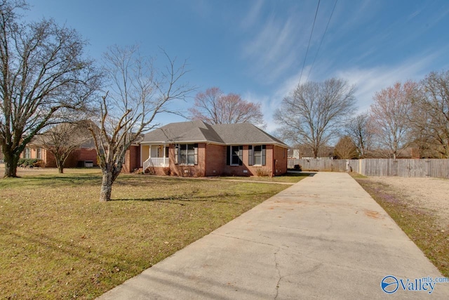 single story home featuring driveway, brick siding, covered porch, fence, and a front yard