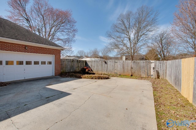 exterior space with a garage and fence