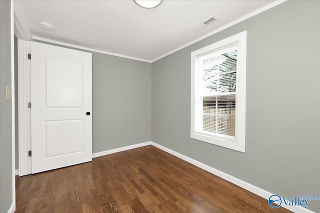 interior space with baseboards, visible vents, crown molding, and wood finished floors