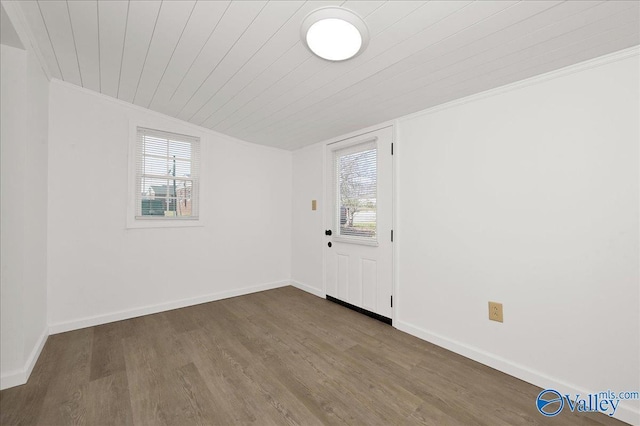 interior space with wood ceiling, baseboards, a wealth of natural light, and wood finished floors
