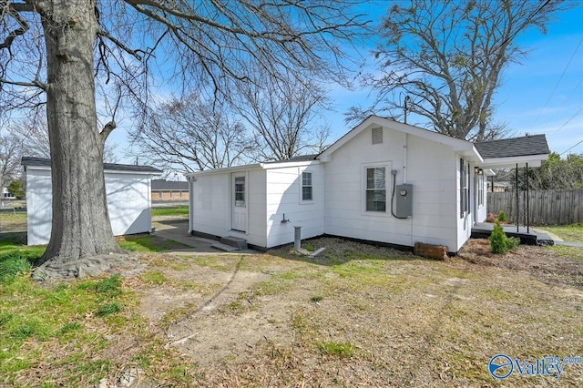 rear view of property featuring fence