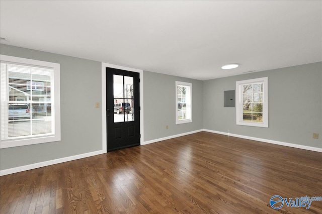 entrance foyer with wood finished floors, electric panel, and baseboards