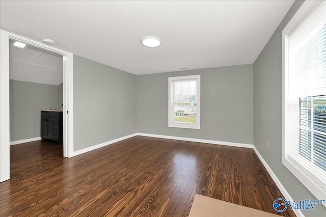 interior space with baseboards and wood finished floors