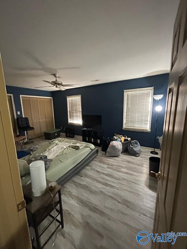 bedroom featuring hardwood / wood-style floors and ceiling fan