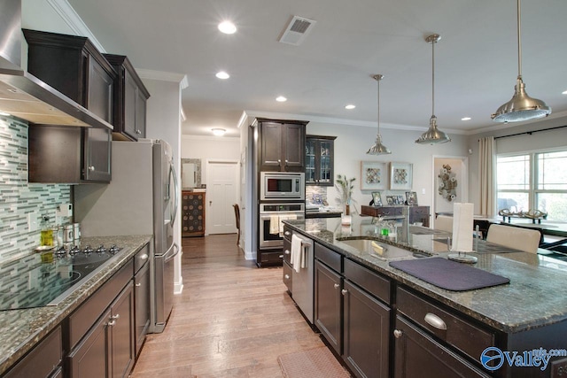 kitchen featuring appliances with stainless steel finishes, backsplash, and pendant lighting