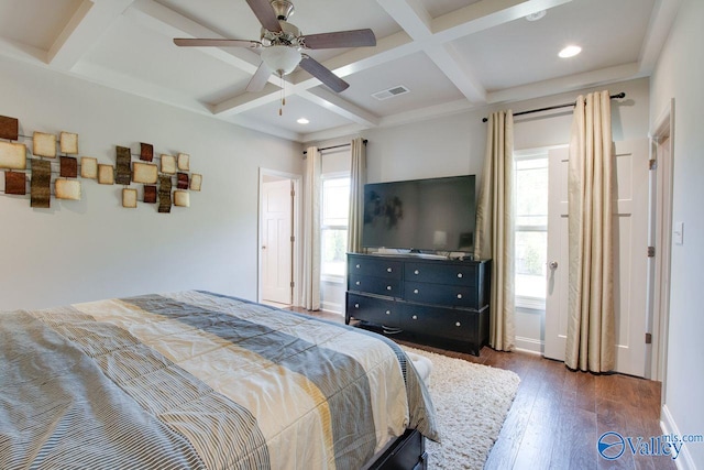 bedroom with dark wood-type flooring, ceiling fan, coffered ceiling, and beamed ceiling