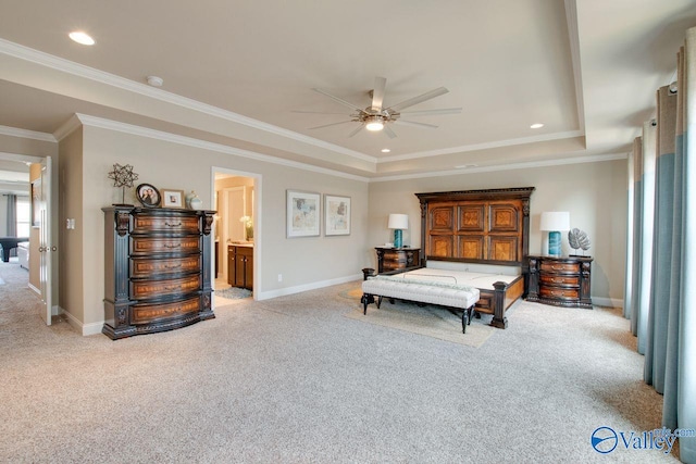 carpeted bedroom featuring connected bathroom, ceiling fan, ornamental molding, and a tray ceiling