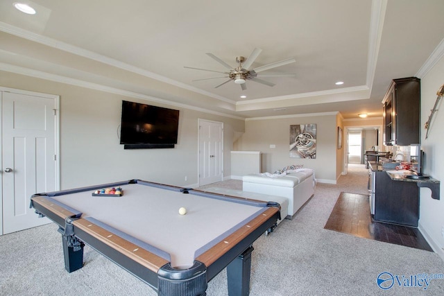 playroom featuring pool table, a tray ceiling, ceiling fan, dark carpet, and ornamental molding