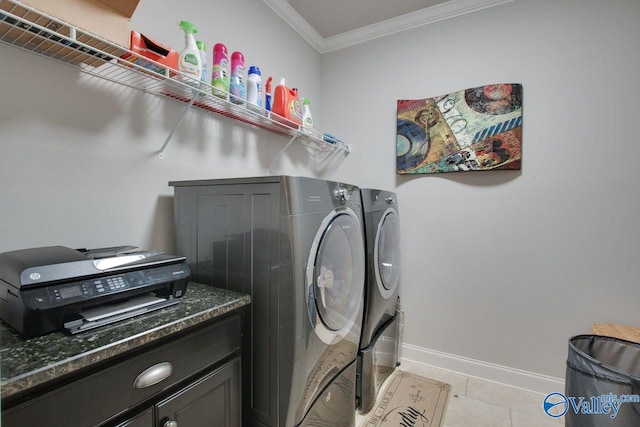 laundry area with crown molding, light tile patterned flooring, and washing machine and dryer