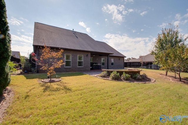 back of property featuring a patio area and a lawn