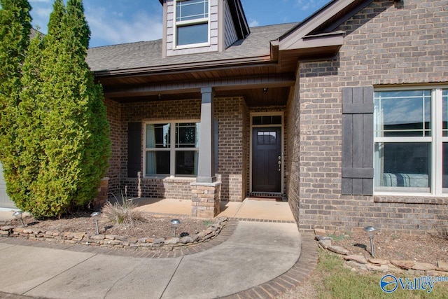 view of exterior entry featuring a porch