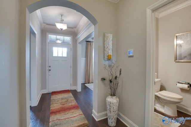 entrance foyer with ornamental molding and dark wood-type flooring