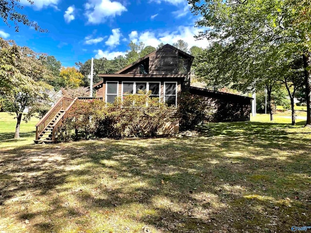 view of side of home featuring a yard