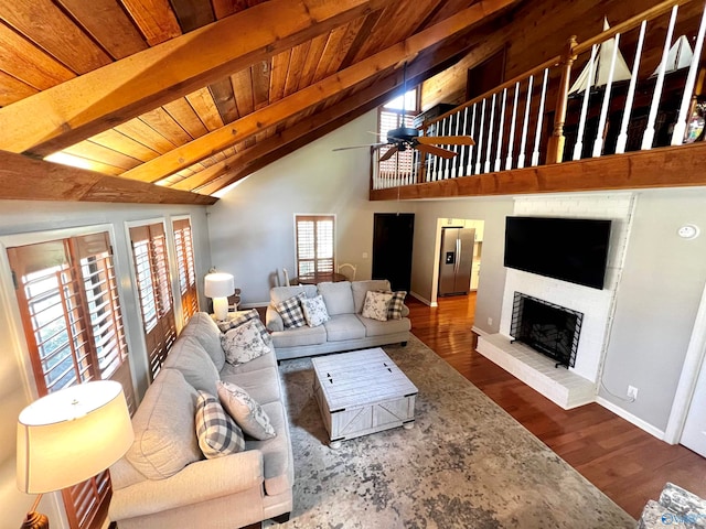 living room featuring beam ceiling and a wealth of natural light