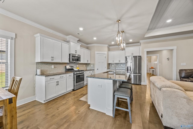 22584 Big Oak Dr, Athens, AL 35613 - kitchen with crown molding, appliances with stainless steel finishes, a breakfast bar area, and a sink