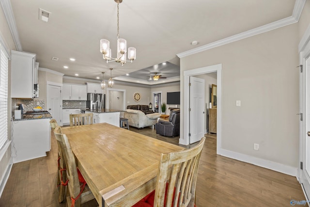 22584 Big Oak Dr, Athens, AL 35613 - dining area featuring crown molding, ceiling fan with notable chandelier, wood-type flooring, baseboards, and recessed lighting
