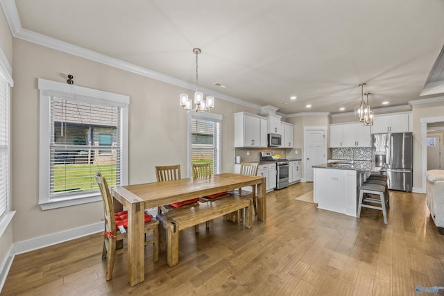 22584 Big Oak Dr, Athens, AL 35613 - dining room featuring an inviting chandelier, crown molding, wood finished floors, and recessed lighting