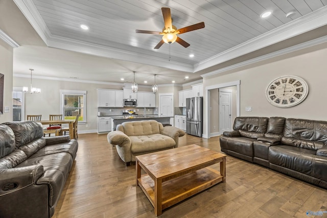 22584 Big Oak Dr, Athens, AL 35613 - living room featuring a tray ceiling, hardwood / wood-style floors, recessed lighting, and ceiling fan with notable chandelier