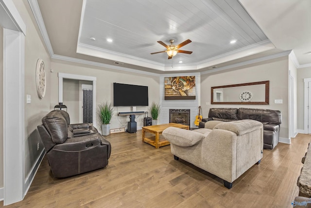 22584 Big Oak Dr, Athens, AL 35613 - living area with a tray ceiling, baseboards, a ceiling fan, wood finished floors, and ornamental molding