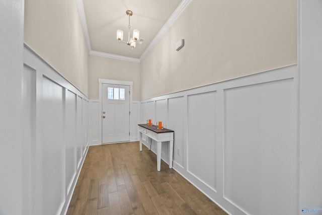 22584 Big Oak Dr, Athens, AL 35613 - entryway with a decorative wall, a chandelier, a wainscoted wall, dark wood finished floors, and ornamental molding