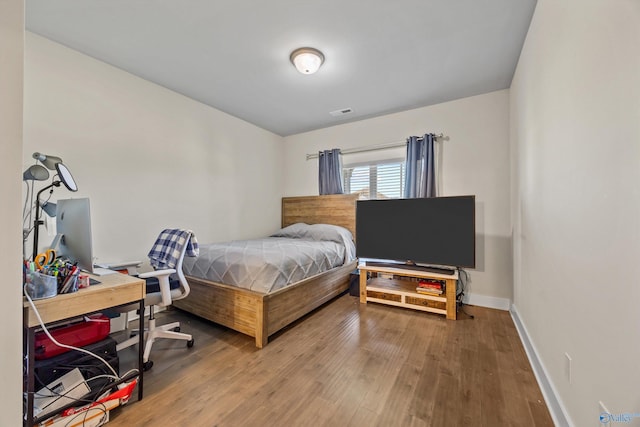22584 Big Oak Dr, Athens, AL 35613 - bedroom with baseboards, wood finished floors, and visible vents