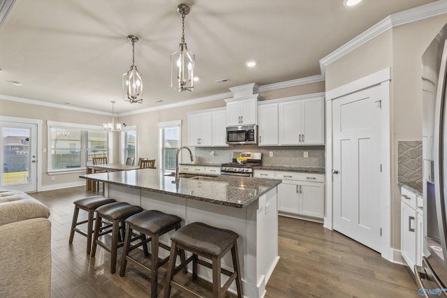 22584 Big Oak Dr, Athens, AL 35613 - kitchen featuring an inviting chandelier, a sink, a kitchen bar, tasteful backsplash, and appliances with stainless steel finishes