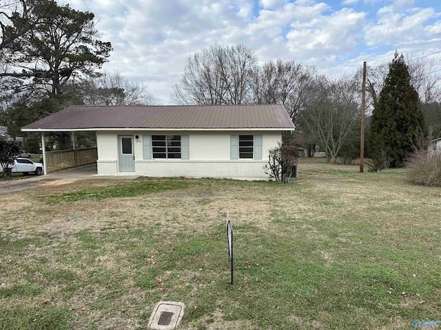 ranch-style home with a front yard and a carport