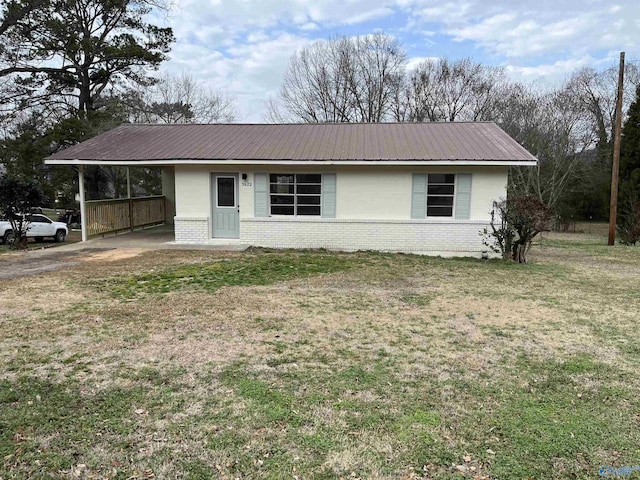 ranch-style home with a front lawn and a carport