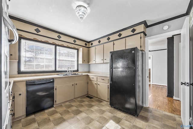 kitchen featuring crown molding, sink, black appliances, light hardwood / wood-style flooring, and cream cabinetry