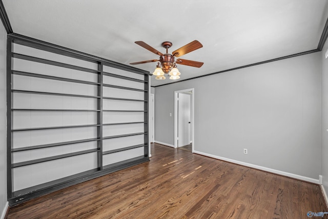 unfurnished room with dark hardwood / wood-style floors, ceiling fan, and ornamental molding