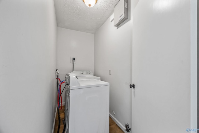 washroom with electric dryer hookup and a textured ceiling