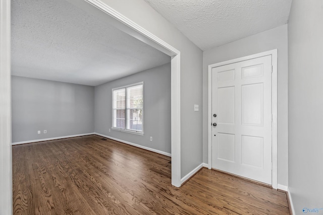 entrance foyer featuring wood-type flooring and a textured ceiling