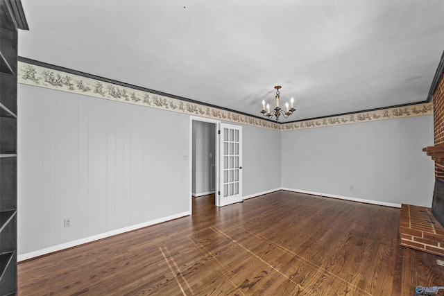 interior space featuring dark hardwood / wood-style floors, an inviting chandelier, and crown molding