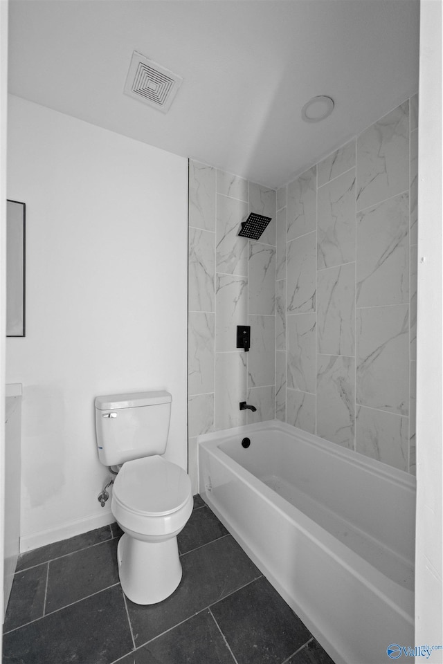 bathroom featuring tile patterned floors, toilet, and tiled shower / bath combo