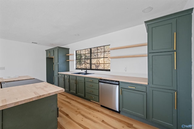 kitchen with butcher block countertops, sink, stainless steel dishwasher, green cabinetry, and light hardwood / wood-style flooring