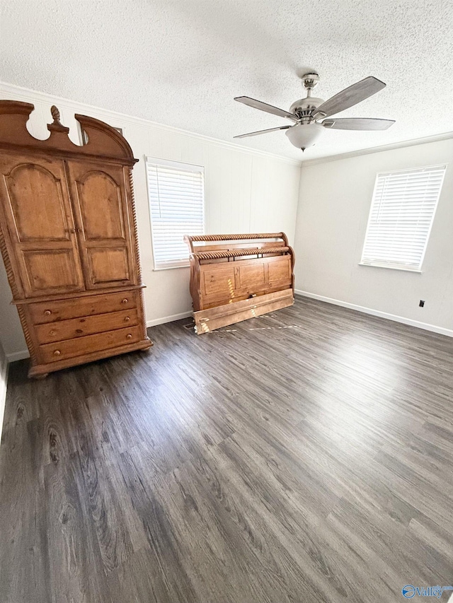 unfurnished bedroom featuring a textured ceiling, ceiling fan, dark hardwood / wood-style floors, and ornamental molding