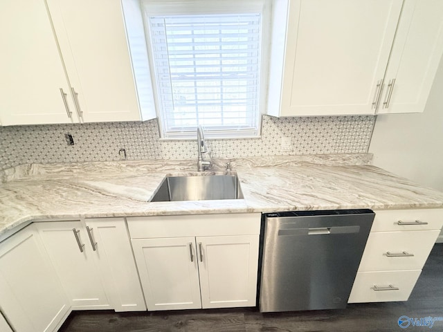 kitchen featuring light stone countertops, sink, white cabinets, and stainless steel dishwasher