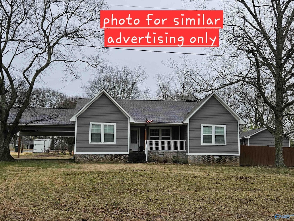 view of front of house with a carport, a porch, and a front yard