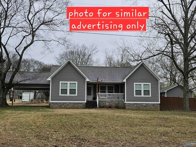 view of front of house with a carport, a porch, and a front yard