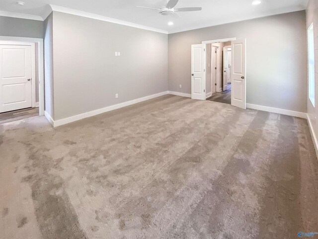 unfurnished room with carpet, ceiling fan, and ornamental molding