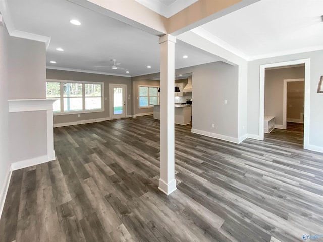 unfurnished living room with ornamental molding, ceiling fan, and dark hardwood / wood-style floors