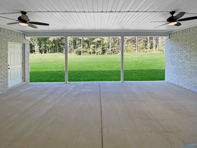 unfurnished sunroom featuring ceiling fan