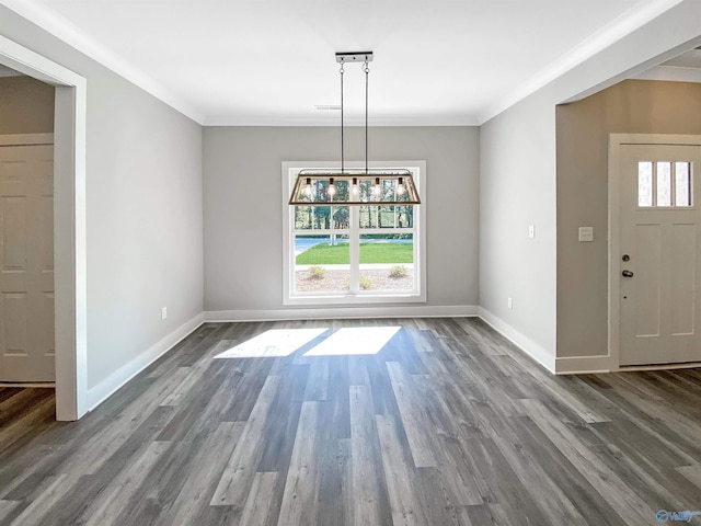 unfurnished dining area with crown molding, hardwood / wood-style floors, and an inviting chandelier