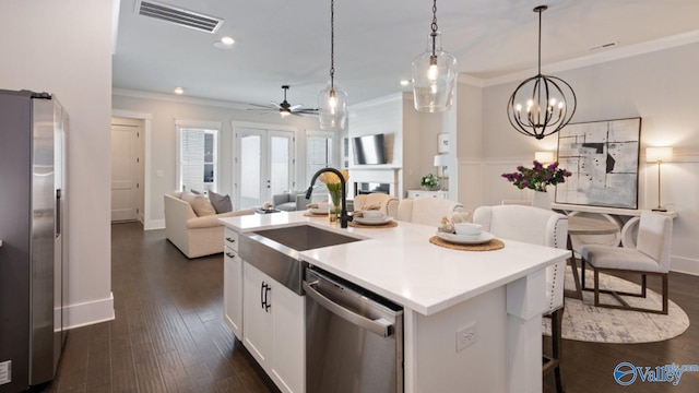 119 Moss Brook Ln, Madison, AL 35757 - kitchen with appliances with stainless steel finishes, a sink, ornamental molding, white cabinets, and ceiling fan