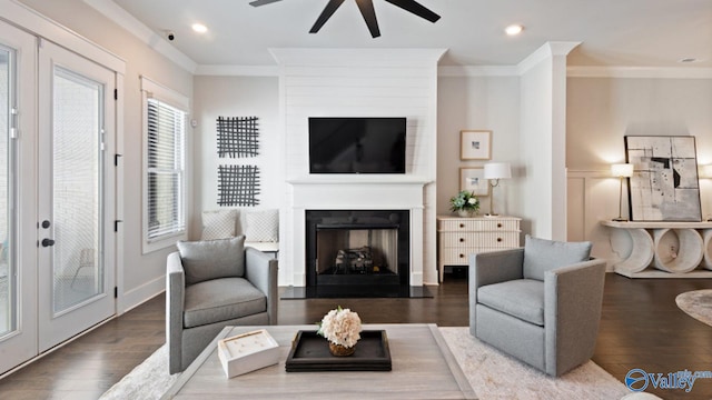 119 Moss Brook Ln, Madison, AL 35757 - living room featuring a ceiling fan, ornamental molding, a large fireplace, wood finished floors, and french doors