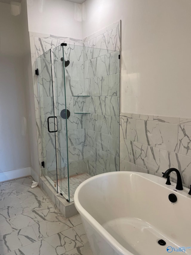 119 Moss Brook Ln, Madison, AL 35757 - full bath with marble look tile flooring, a soaking tub, and a marble finish shower