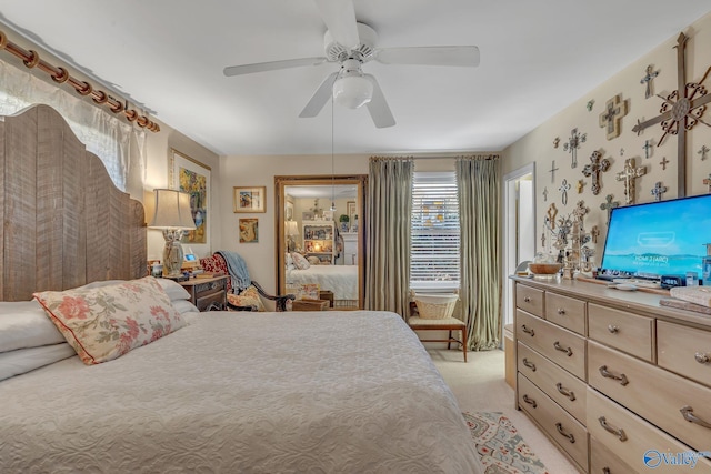 bedroom with wallpapered walls, light carpet, and ceiling fan